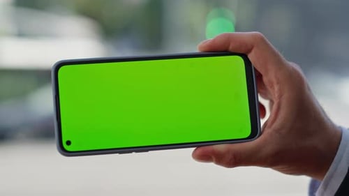 Hand Touching Green Screen Smartphone Holding at Panoramic Window Alone Closeup