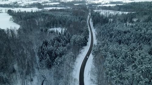 Panoramic View Of Winter Road In The Woods During Snowy Season In Pieszkowo Poland - aerial drone sh