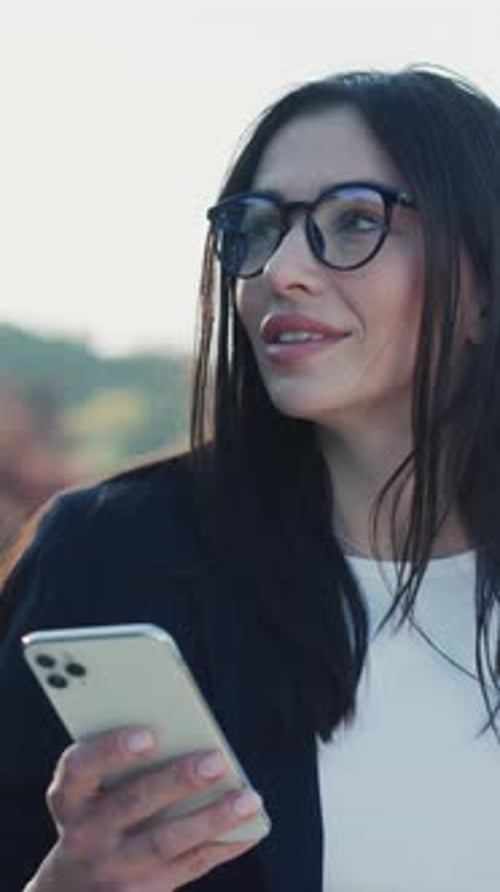 Face Young Attractive Woman Walking Using the Phone in Urban City at Sunlight Look Around in Park
