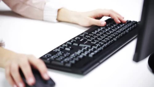 Woman Typing on Black Keyboard at Desk