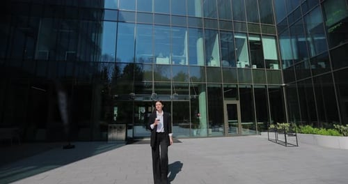 Young Businesswoman Walking in Central Business District in City Professional Woman Walking Outdoors