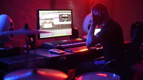 Sound engineer working and mixing music indoors in the studio