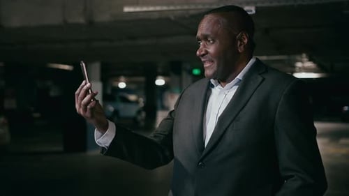 Adult Man Video Calling in a Parking Garage