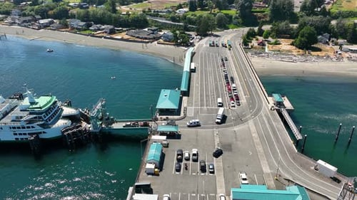 Aerial view of cars loading onto a ferry leaving Clinton, WA.