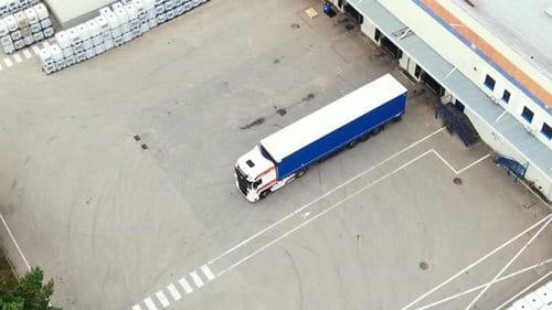 Aerial View of Semi Truck Loading at Modern Logistics Warehouse