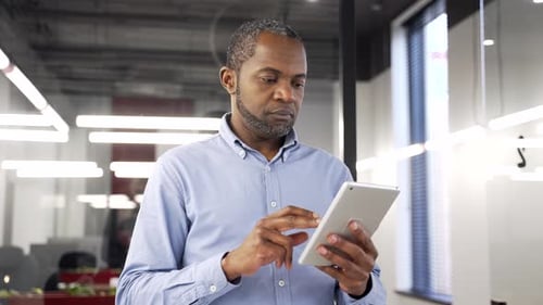 Man Using Tablet Computer in Modern Office