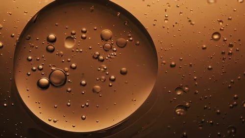 Closeup View of Numerous Bubbles Floating in a Rich Amber Liquid Creating Beauty and Intrigue