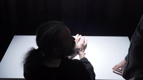 Intense Interrogation of Suspect at Table