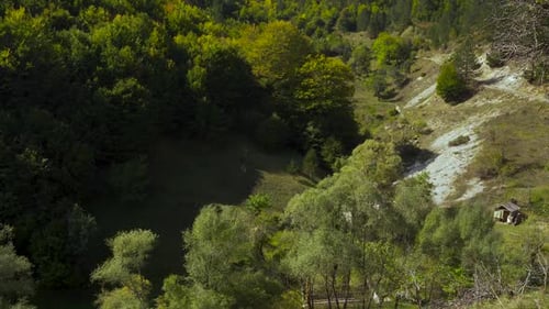 Valley with sharp slopes covered in lush vegetation and green trees of the forest in Balkans mountai