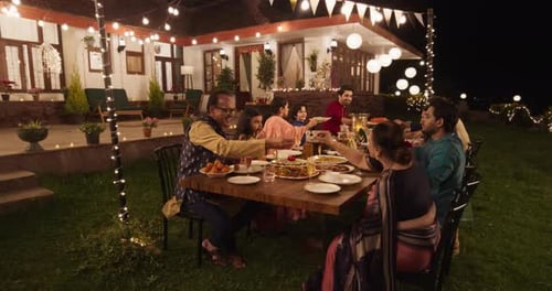 Big Indian Family Garden Party Celebration, Gathered Together at the Table in Ba