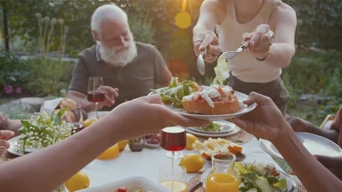 Friends and Family Gather for Outdoor Meal Celebration