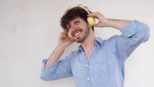 Italian Man Dancing Laughing While Listening to Music with Headphones