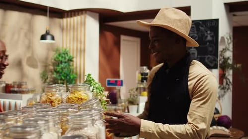 Smiling Shopkeeper Helping Customer in Organic Food Store