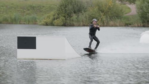 Surfer Practicing Tricks on Wakeboard in Cable Park