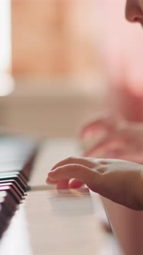 Child's Hands Playing Piano Close Up, Portrait Orientation