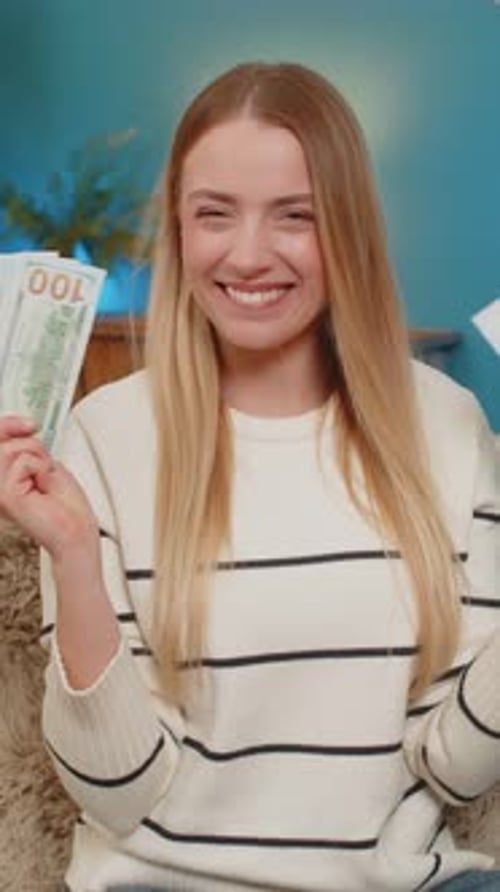 Excited Woman Holding Money and Letter Indoors