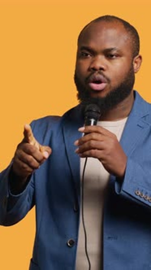 Vertical Video Motivational Speaker Holding Monologue Using Microphone Studio Background