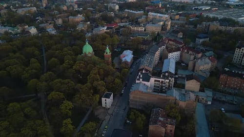 Panoramic View of a European City with Historical Buildings Church Domes and Greenery Under a