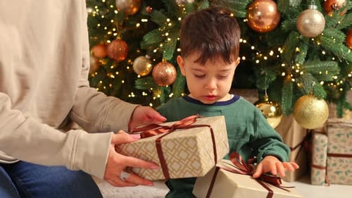 Child Receives Christmas Gift From Adult