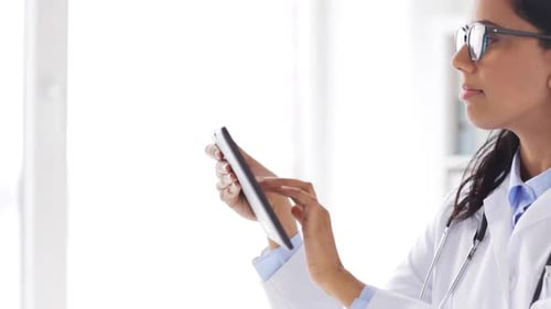 Woman Doctor Using Tablet in a Bright Office