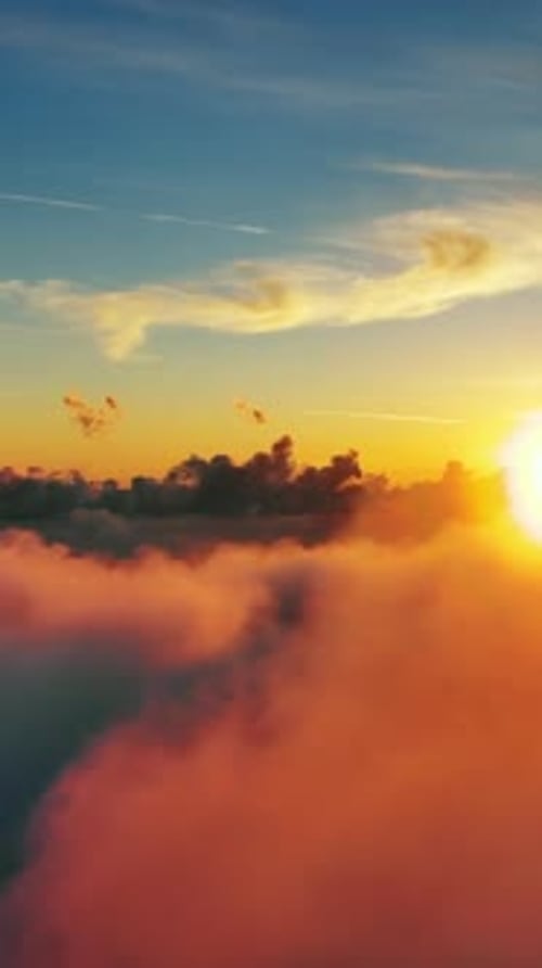Aerial view of clouds and sunset sun