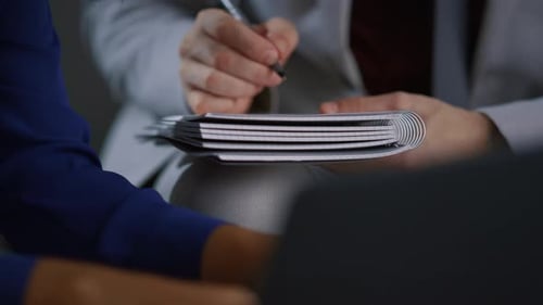 Businessman Hand Writing Notebook Working At Corporate Meeting Office Workplace. Unknown Caucasia...