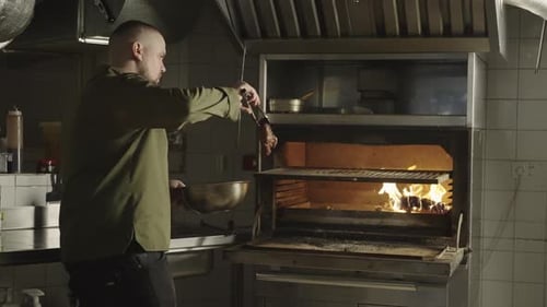 The Chef Puts a Piece of Steak on the Grill