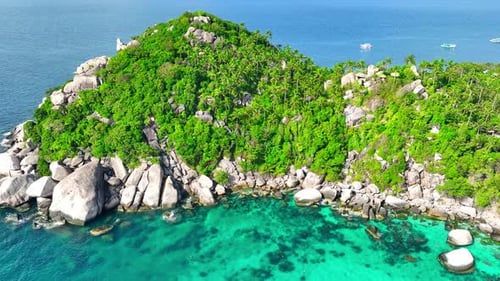Rocky coastline with green forests and unique blue turquoise sea water.