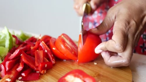 Close Up of Dicing Tomato on Cutting Board