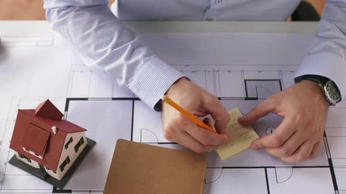 Architect working on house plans in office