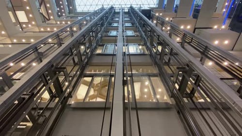 Work Escalator with Lighting in a Shopping Center An Automatic Staircase Moves Downward in a Public