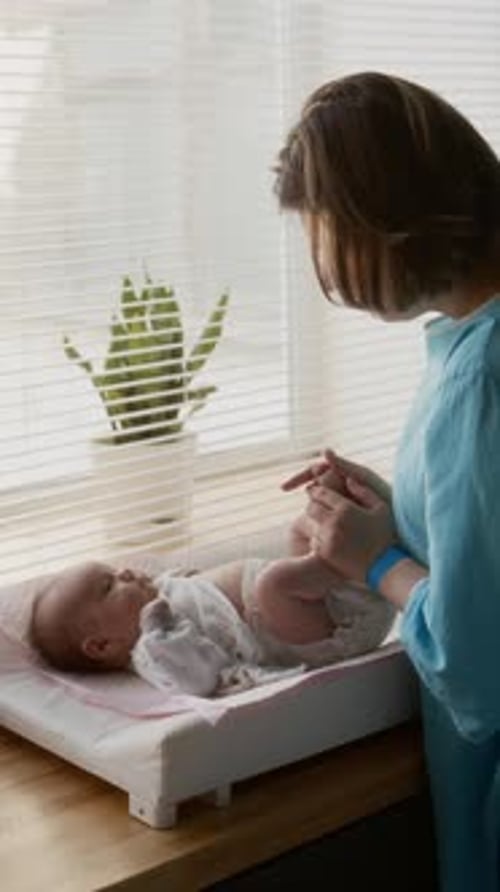 Woman Having Fun with Baby After Changing Diapers
