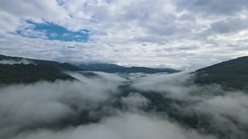 Top Aerial View of Mountain Cloud Around Forest on Mountain Hills Sunlight From Clouds Slow Motion