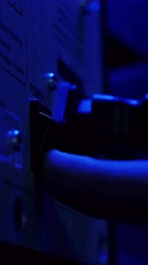 Fingers press computer power start button, close up. Vertical video