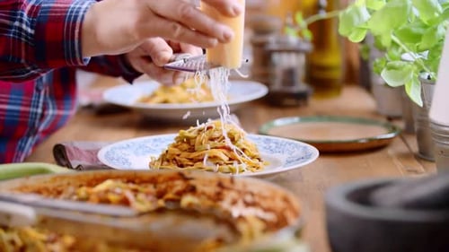Gratin Dish Preparation, Grating Cheese on Pasta Dish
