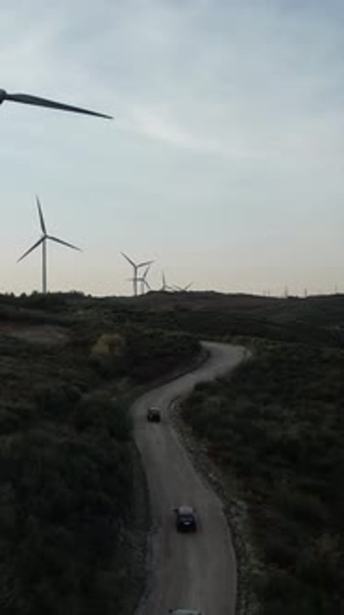 Traveling in Mountain Road with Windmills Vertical Video
