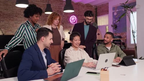 Coworkers Collaborating on Project in Modern Office in Slow Motion