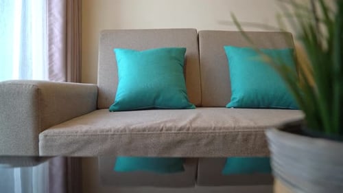 Sofa with Teal Pillows in Modern Living Room