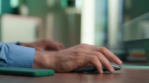 Man Typing on Keyboard Using Computer Mouse