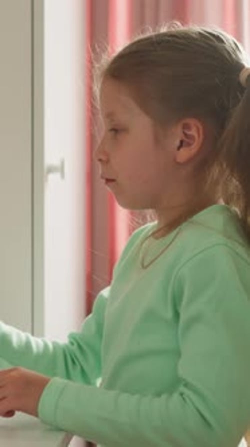 Calm Girl Takes Off Cap From Felttip Pen Sitting at Desk