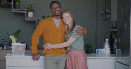 Affectionate Couple Embracing in Bright Modern Kitchen