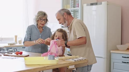 Grandparents Helping Granddaughter Pack Lunch for School in Slow Motion