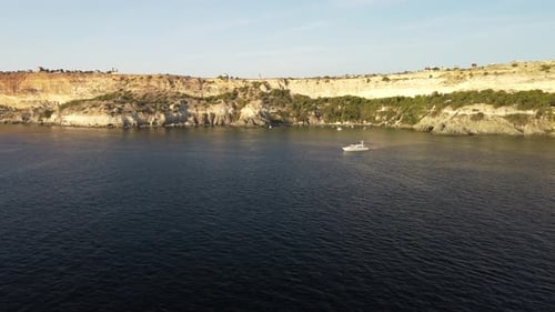 Aerial View of a Luxury Sailing Ship with White Sails in the Sea in the Evening Sunlight Luxurious