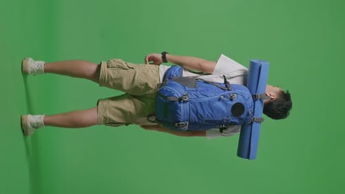 Full Body Back View Of A Male Hiker Backpack Looking Around While Standing On Green Screen