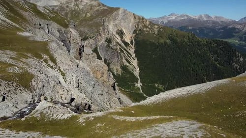 mountain river falls from the rocks, aerial crane shot