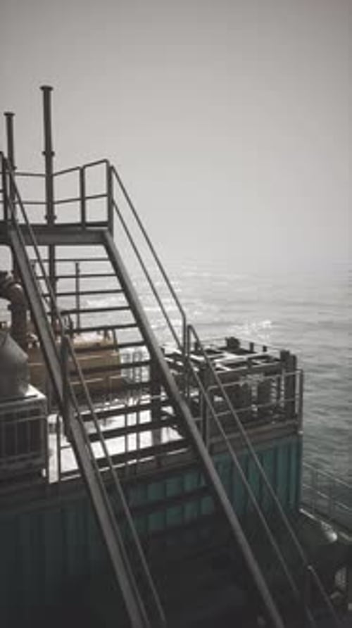 Exploring the Rugged Structure of an Oil Rig Under Hazy Sky Conditions