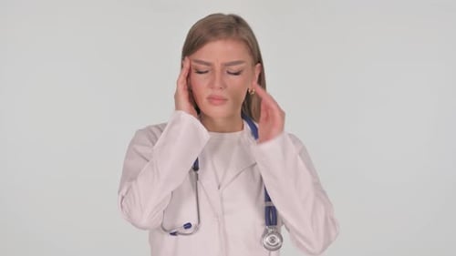 Female Doctor Rubbing Temples in Discomfort