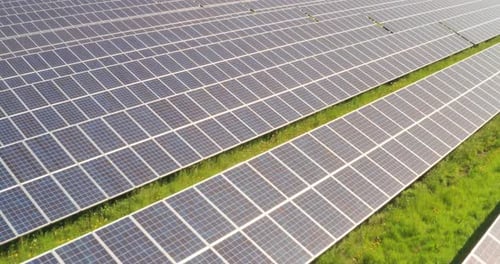 Aerial shot of photovoltaic sun panels used for renewable clean energy in a sunny day.