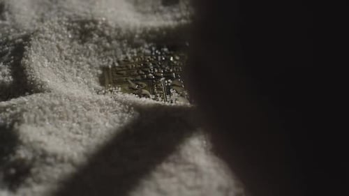 Brushing away sand to reveal artifact