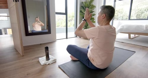 Man Practicing Yoga on Mat in Bright Home